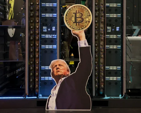 a cutout of a man holding up a bitcoin